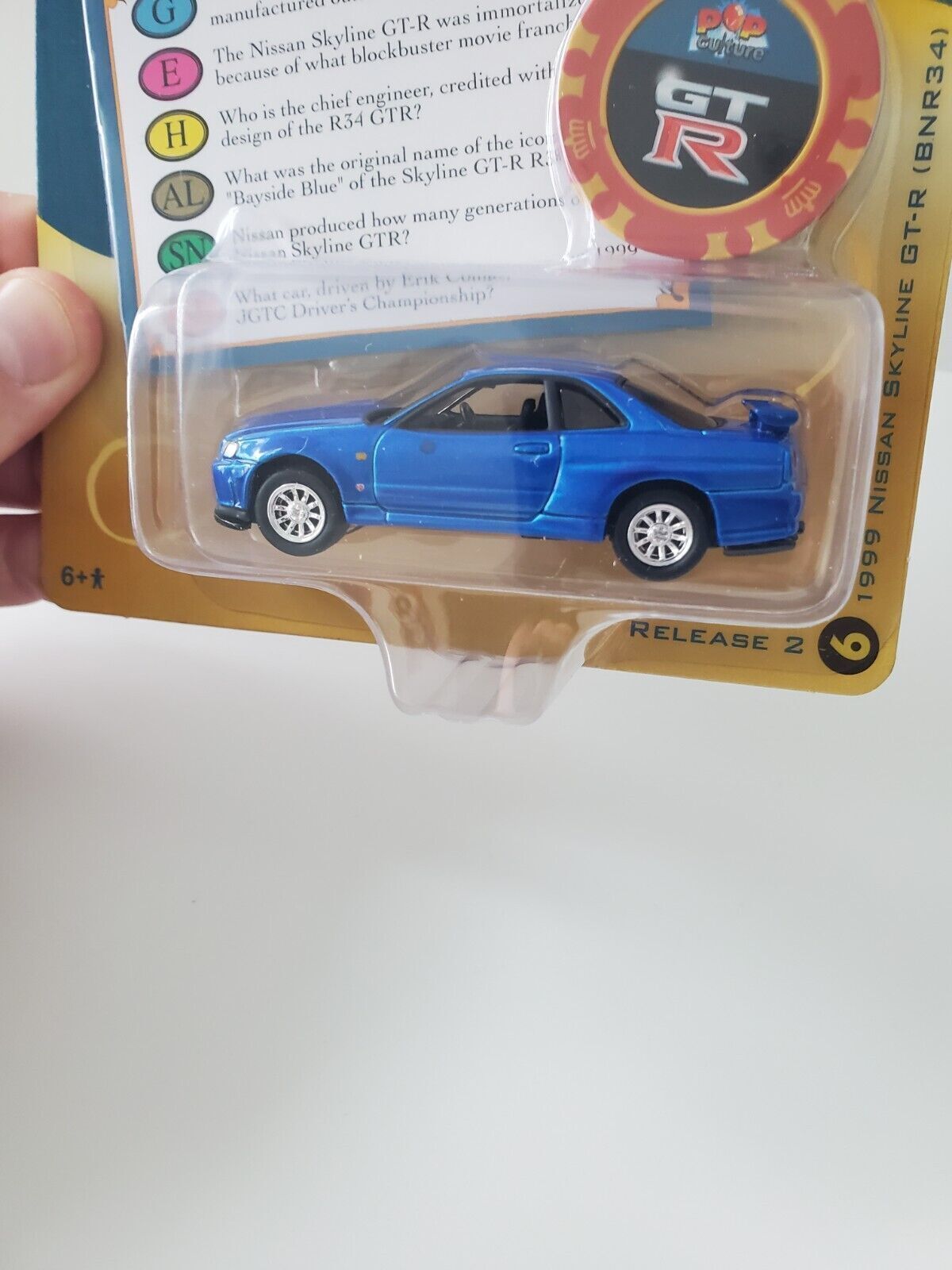 2022 Johnny Lightning Trivial Pursuit 1999 Nissan Skyline GT-R (BNR34)